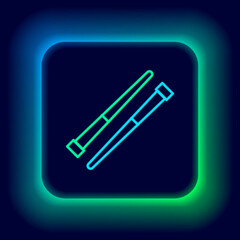 Glowing neon line Food chopsticks icon isolated on black background. Wooden Korean sticks for Asian dishes. Oriental utensils. Colorful outline concept. Vector