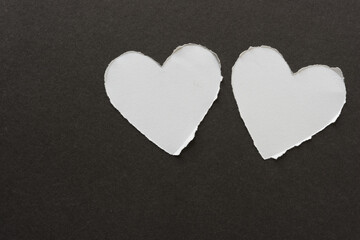 torn paper hearts on a dark background