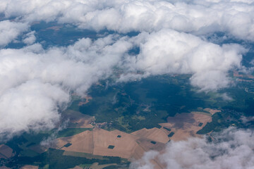 Fields in France as seen from the air through light clouds