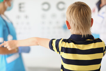 Little boy stands in the ophthalmologists office