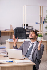 Young male employee working in the office