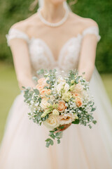 Bride holds a boho bridal bouquet with eucalyptus