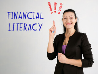 Financial concept meaning FINANCIAL LITERACY exclamation marks with phrase on the wall