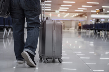 Traveler passenger hold luggage at terminal airport or transit flight with suitcase in journey...