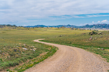 Fototapeta na wymiar Dirt Road Path in Rocky Mountains of Wyoming Countryside