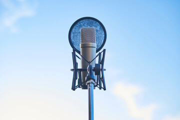 studio condenser microphone on sky background. Copy space