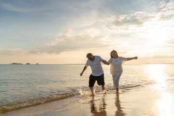 Family On Summer Beach Vacation, healthy older couple running on sea beach, Concept for .caring for the elderly, Caregiving to older persons and relations of the family to support elderly state