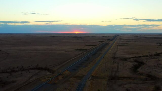 Desolate Road Next To Railway On Sunset At Queensland Outback In Australia. - Aerial Drone