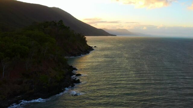 Sunset beyond the mountains of Cairns Palm Cove in Australia -Aerial