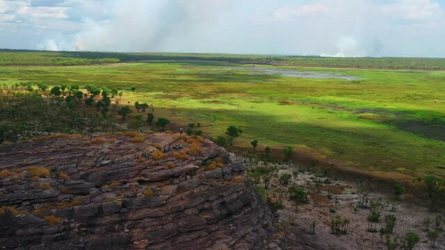 Tourist Hiker Near The Edge Of Rock Formation At Ubirr, Kakadu National Park, Northern Territory, Australia. - Aerial