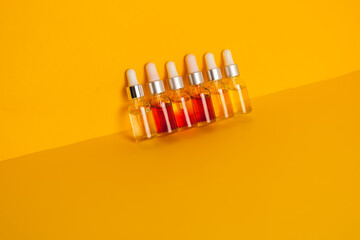 Dropper glass bottles with pipette. Transparent hyaluronic natural beauty mineral product and eco serum skin care concept. Top horizontal view copyspace. Summer juicy colors.