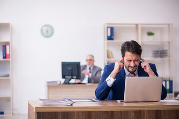 Two male employees working in the office