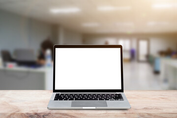 Laptop computer with blank screen on wood table over blur background. Mock up, template for your design.
