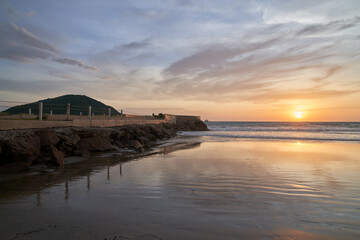 Fototapeta na wymiar Scenic Beach Sunset in Mazatlán Mexico with View of Pier and Tide Out 