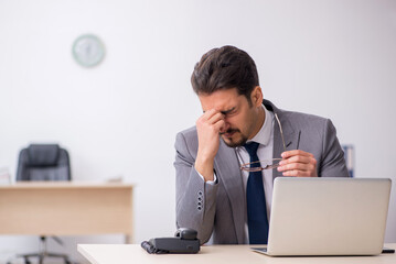 Young male employee working in the office