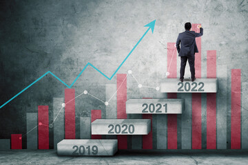 Male manager draws growth chart on 2022 numbers