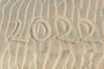 Fototapeta na wymiar Number 2021 written on the sand of tropical beach