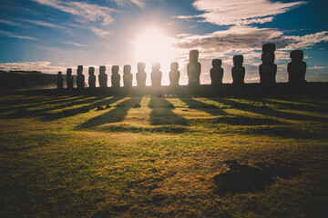 Sunrise over Moai stone sculptures at Ahu Tongariki, Easter island, Chile.
