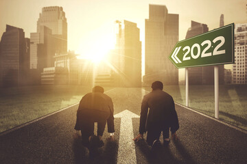 Two businessmen with 2022 numbers on signpost