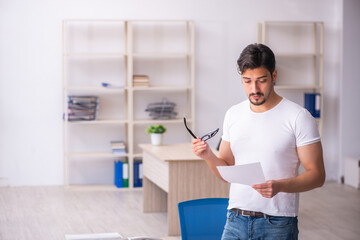 Young male student employee at workplace