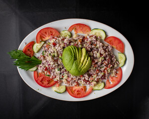 Fish and shrimp ceviche dish with avocado, tomato and onion, Mexican food