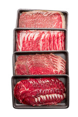 Group of mix raw beef. Sliced raw beef place in a row on a black plastic tray isolated on a white background. Sliced ​​meat for cooking, fresh meat for grilling, yakiniku, sukiyaki or shabu.