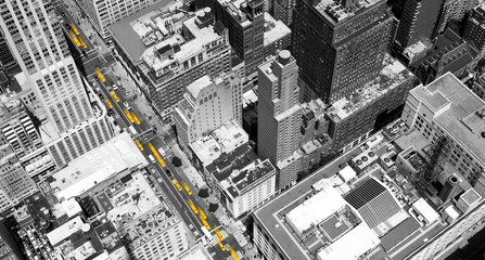Overhead view of yellow taxis driving through the black and white buildings of Midtown Manhattan in New York City - 453713188