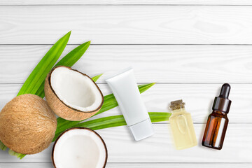 Fototapeta na wymiar Skin care cream natural product with coconut fruit isolated on wooden table background. Organic cosmetic beauty and spa concept.Top view. Flat lay.