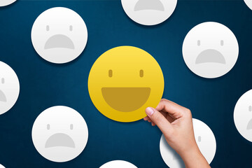 Customer giving smile emoticon for rating on blue background. Service rating, feedback,...