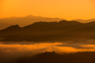 Aerial view Beautiful of morning scenery Golden light sunrise And the mist flows on high mountains and forest , Wonder fog.