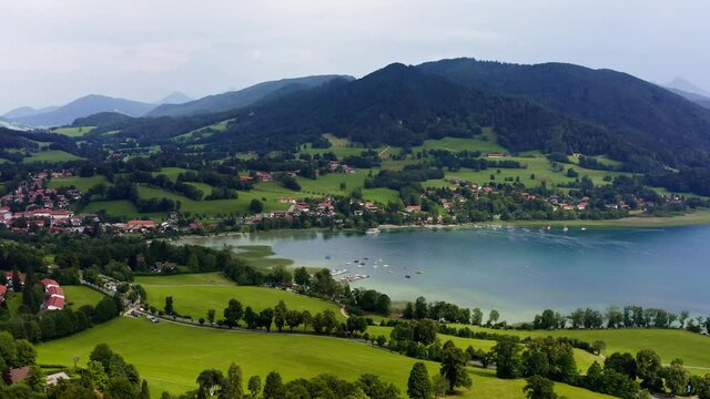 Panning shot over the Tegernsee, a popular recreation aera lake with the aerial view from Gmund over the beautyful lake in mountain range next to the alps.