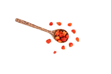 Group of dried strawberries in a wooden spoon isolated on white background.