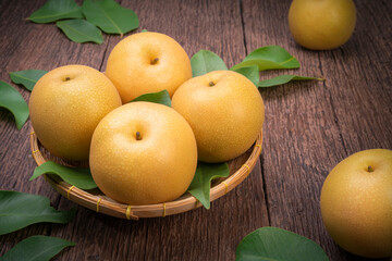Naklejka na ściany i meble Snow pear or Shingo pear on a wooden background, Nashi pear fruits delicious and sweet on wooden background.
