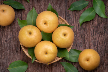 Snow pear or Shingo pear on a wooden background, Nashi pear fruits delicious and sweet on wooden background.