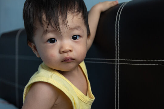 Portrait Adorable And Happy Chinese 1 Year Old Baby Boy Child Playing On Bed