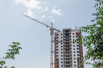 Fototapeta na wymiar Construction of a multi-storey building, affordable housing, mortgages, apartments for military personnel, young families, construction in a green zone. selective focus