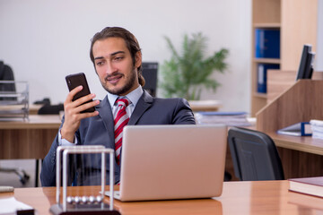 Young man businessman employee sitting in the office