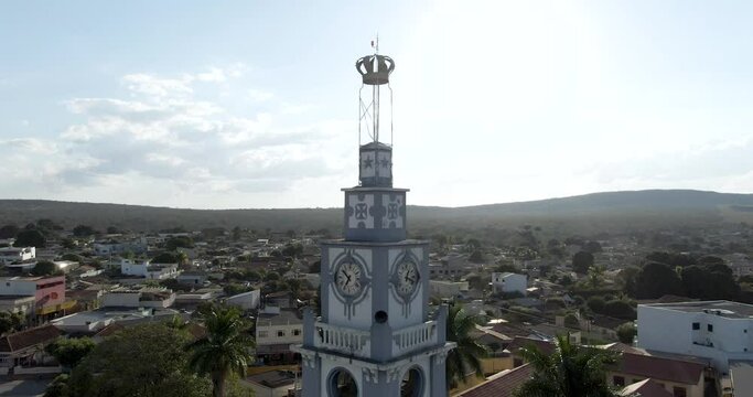 Slow aerial circling on church clock tower, Corinto city in background. Brazil