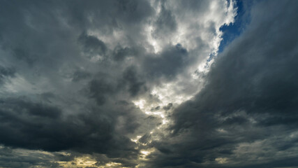 Fototapeta na wymiar Dramatic storm clouds at dark sky