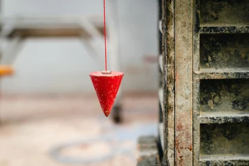 Foto op Canvas pendulum with plum for finding vertical line © tortoon