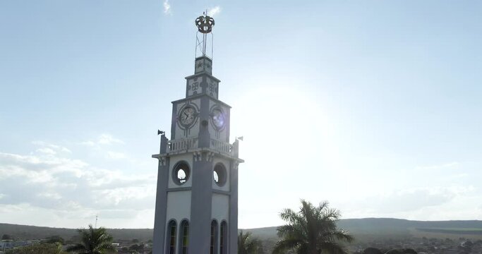 Slow aerial circling on church tower against sunlight. Corinto, Brazil