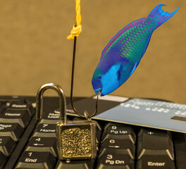 Phishing. Fish hook, lock key and credit card on computer keyboard. Computer crime, Data theft,...