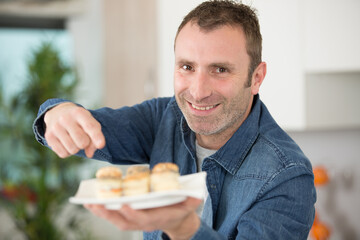 man preparing tapas for visitors at home