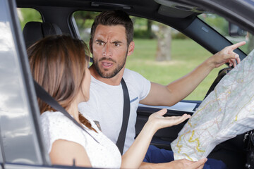 man and woman arguing inside of a car