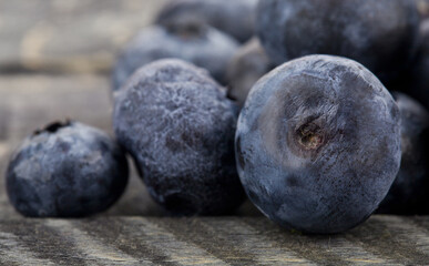 Juicy fresh blueberries on a wooden background.