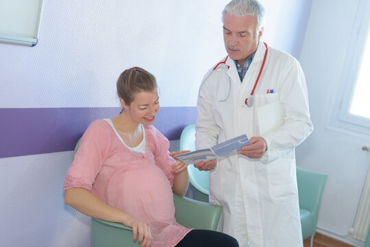 pregnant woman with her doctor in clinic