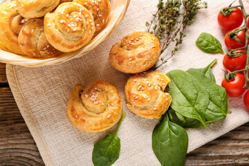 Puff pastry stuffed with spinach and vegetables on wooden background