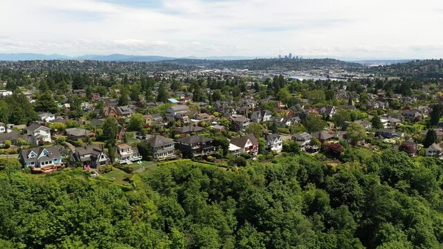 Cinematic 4K aerial drone trucking shot of Sunset Hill, Loyal Heights, Adams, Lawtonwood, Ballard near Seattle, by Puget Sound in Washington