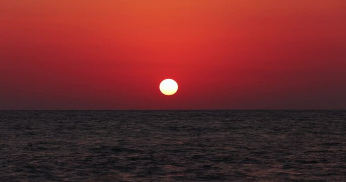 Time lapse of the sun setting in August on the sea of Sabaudia, Italy