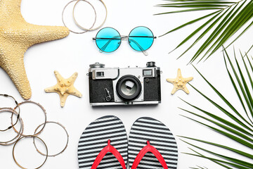 Fototapeta na wymiar Set of beach accessories and photo camera on white background